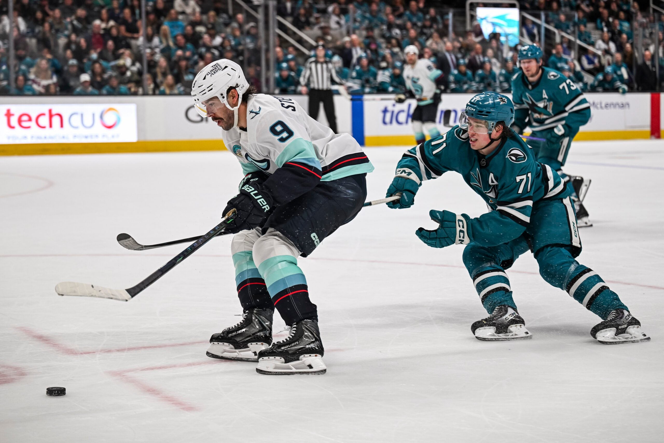 Dec 20, 2025; San Jose, California, USA; Seattle Kraken center Chandler Stephenson (9) and San Jose Sharks center Macklin Celebrini (71) go for the puck during the third period at SAP Center at San Jose. Mandatory Credit: Justine Willard-Imagn Images