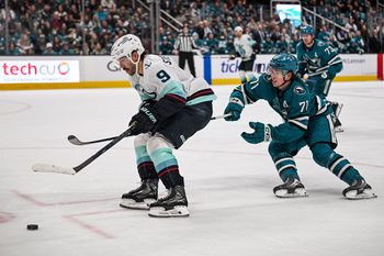 Dec 20, 2025; San Jose, California, USA; Seattle Kraken center Chandler Stephenson (9) and San Jose Sharks center Macklin Celebrini (71) go for the puck during the third period at SAP Center at San Jose. Mandatory Credit: Justine Willard-Imagn Images