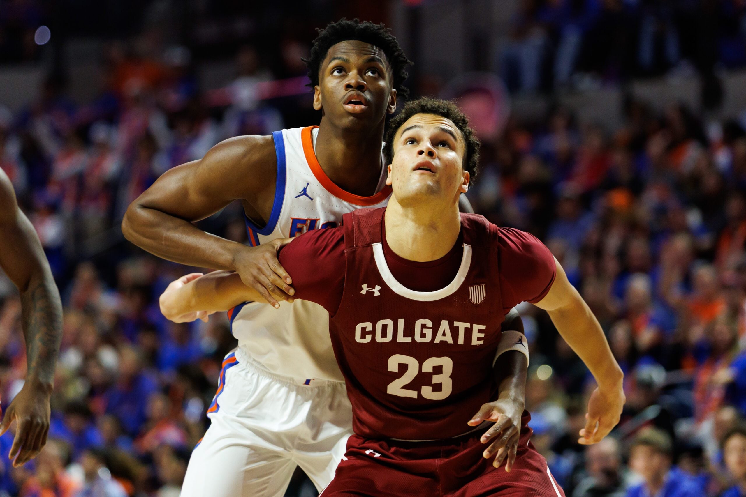 Dec 21, 2025; Gainesville, Florida, USA; Florida Gators guard CJ Ingram II (11) battles with Colgate Raiders forward Cooper Wright (23) for the rebound during the second half at Exactech Arena at the Stephen C. O'Connell Center. Mandatory Credit: Matt Pendleton-Imagn Images