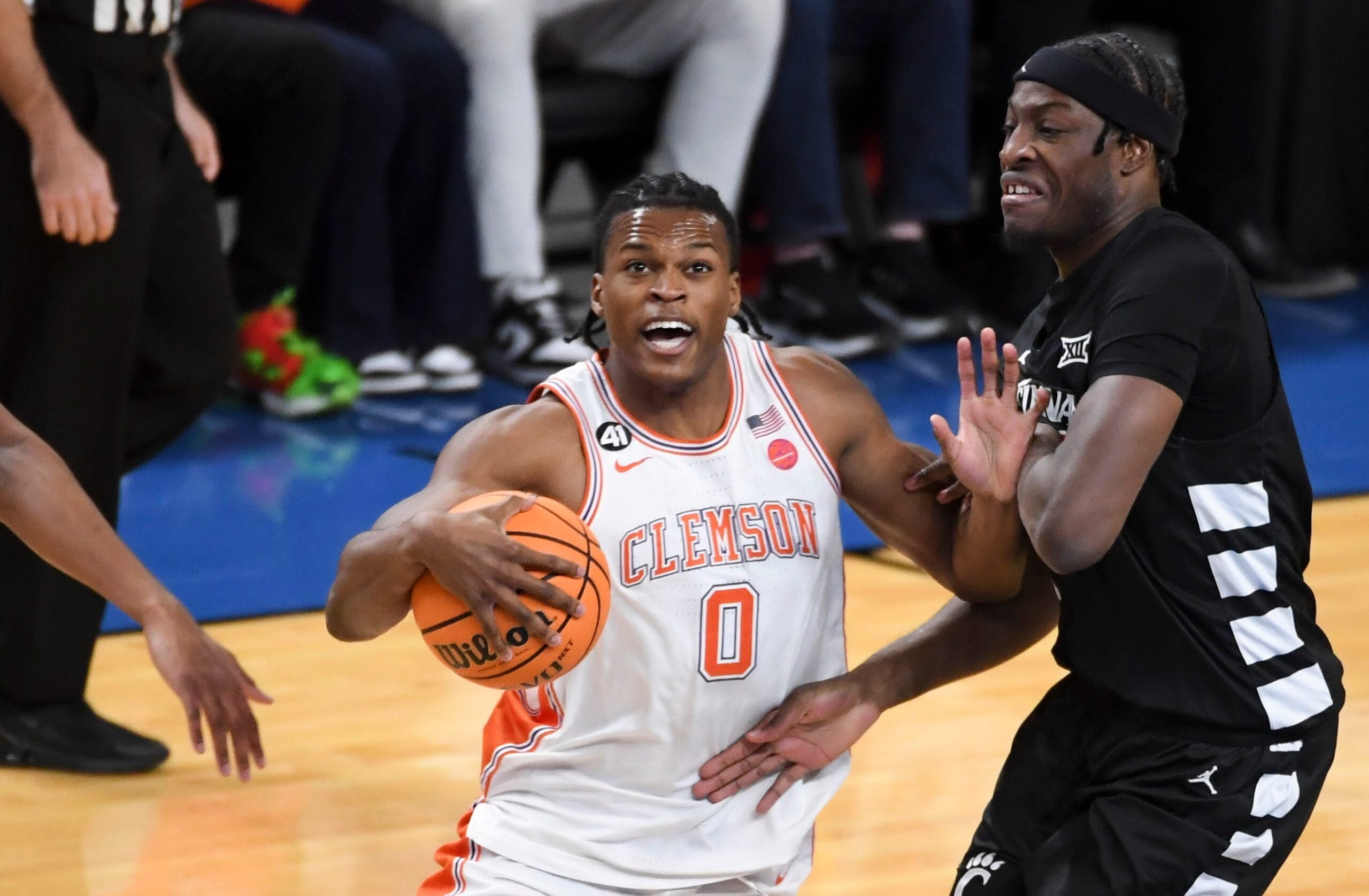 Clemson Tigers forward RJ Godfrey (0) drives past Cincinnati Bearcats forward Halvine Dzellat (65) Sunday, Dec. 21, 2025, during the NCAA men’s basketball game at Bon Secours Wellness Arena in Greenville, South Carolina.