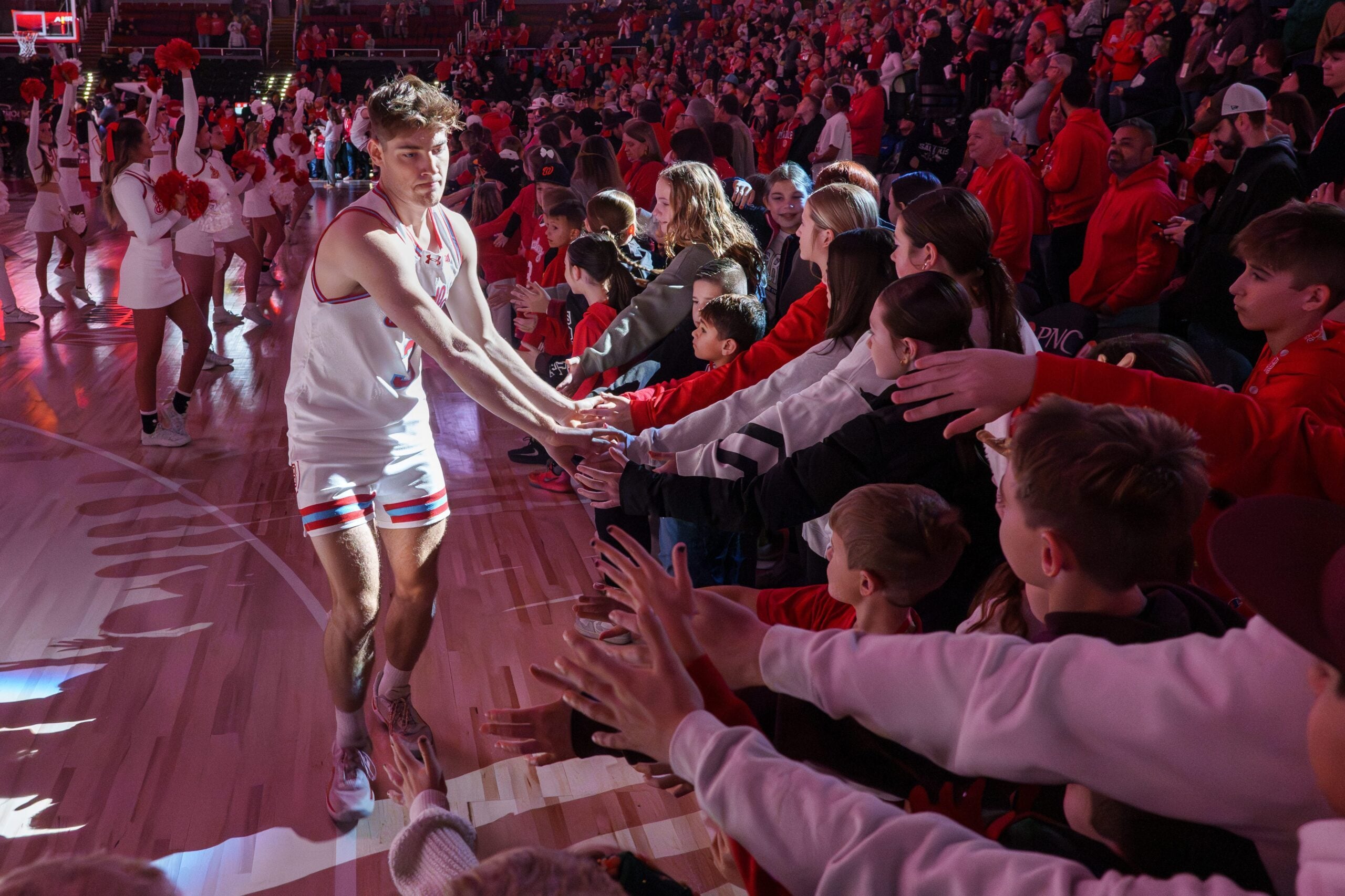Bradley’s Alex Huibregtse takes the spotlight during player introductions before the start of the Braves’ Missouri Valley Conference college basketball home opener against SIU on Sunday, Dec. 21, 2025 at Carver Arena in Peoria. The Braves defeated the Salukis 73-69.