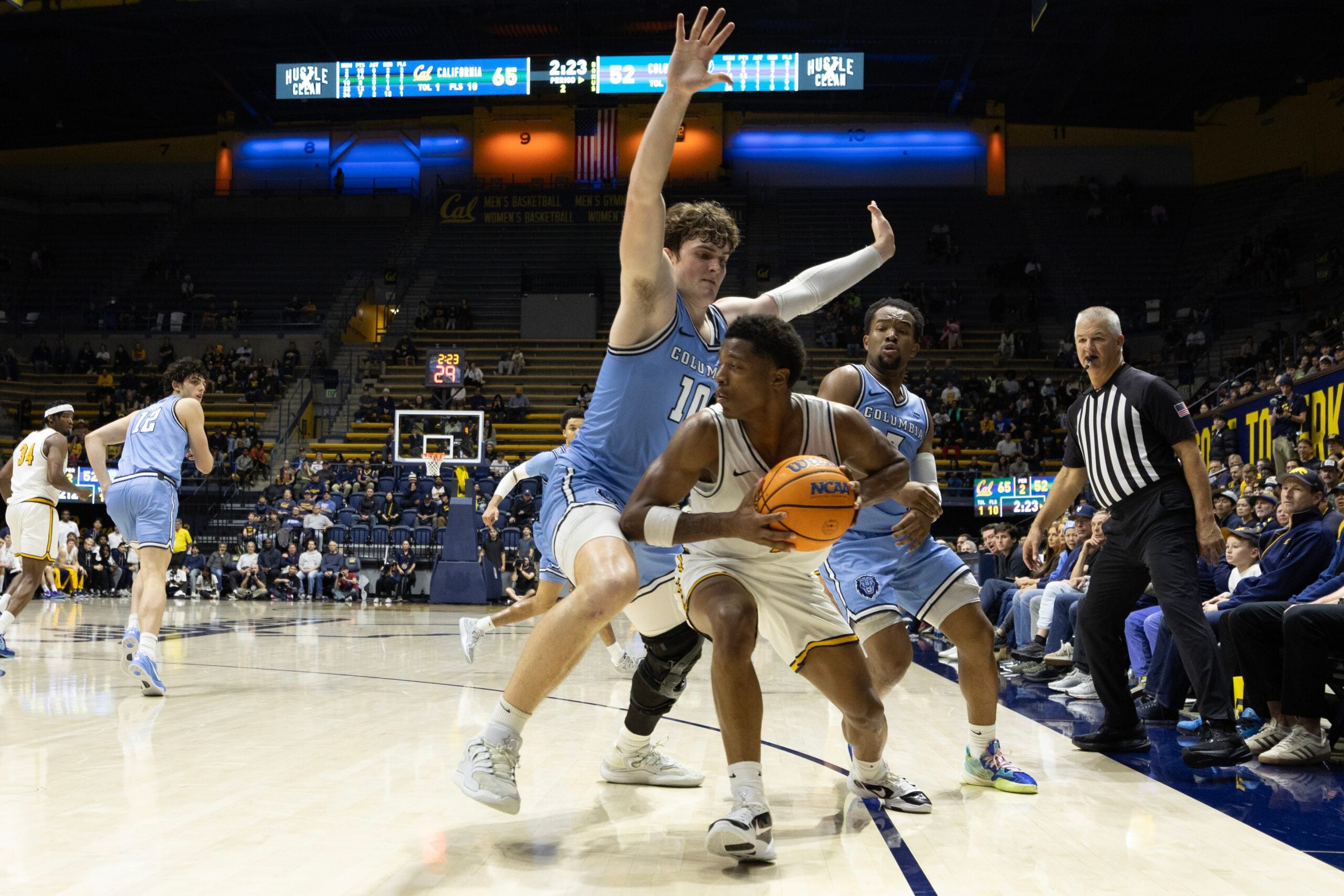 Dec 21, 2025; Berkeley, California, USA; California Golden Bears guard Dai Dai Ames (7) looks to pass around Columbia Lions forward Connor Igoe (10) during the second half at Haas Pavilion. Mandatory Credit: D. Ross Cameron-Imagn Images