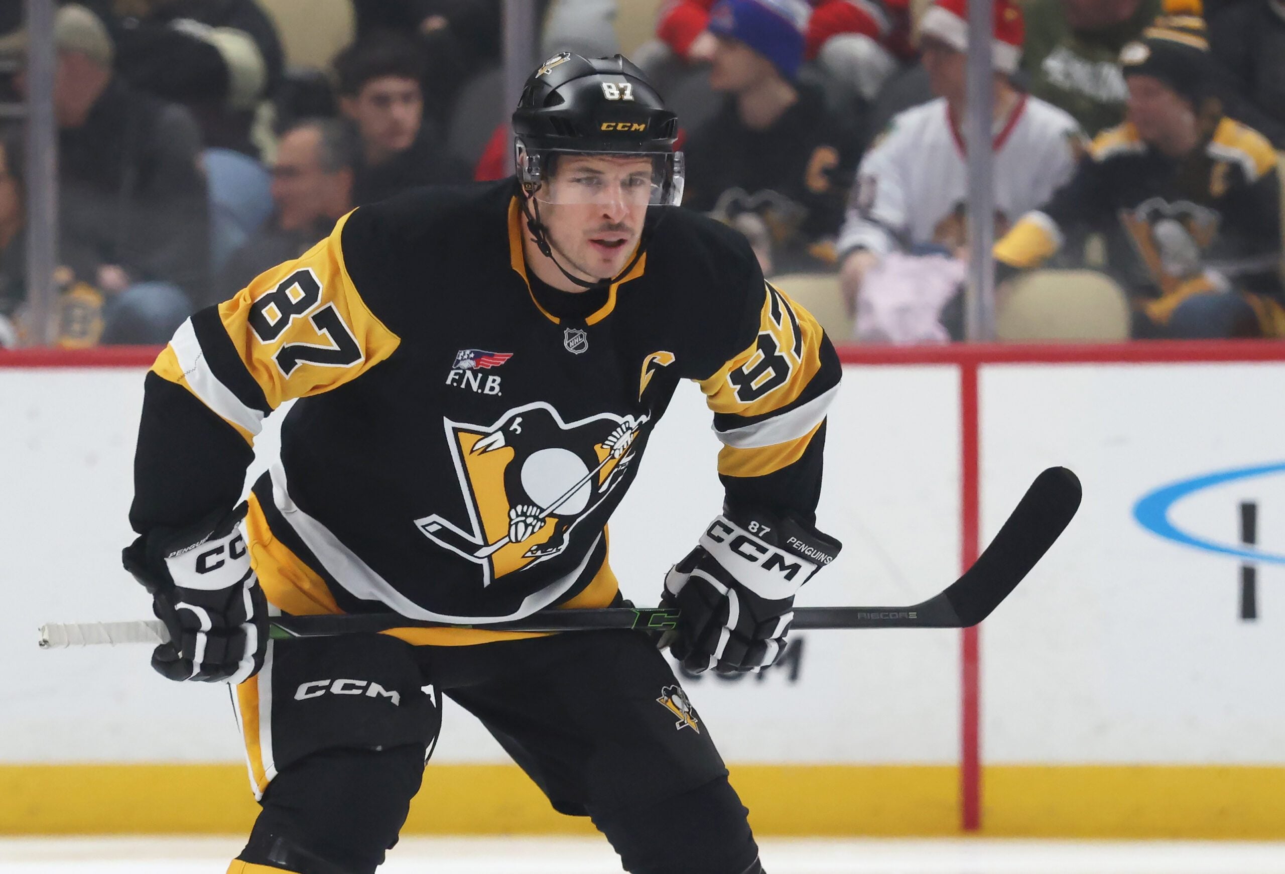 Dec 21, 2025; Pittsburgh, Pennsylvania, USA;  Pittsburgh Penguins center Sidney Crosby (87) gets set for the opening face-off against the Montréal Canadiens during the first period at PPG Paints Arena. Mandatory Credit: Charles LeClaire-Imagn Images