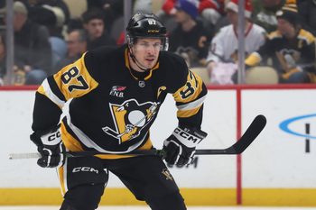Dec 21, 2025; Pittsburgh, Pennsylvania, USA;  Pittsburgh Penguins center Sidney Crosby (87) gets set for the opening face-off against the Montréal Canadiens during the first period at PPG Paints Arena. Mandatory Credit: Charles LeClaire-Imagn Images