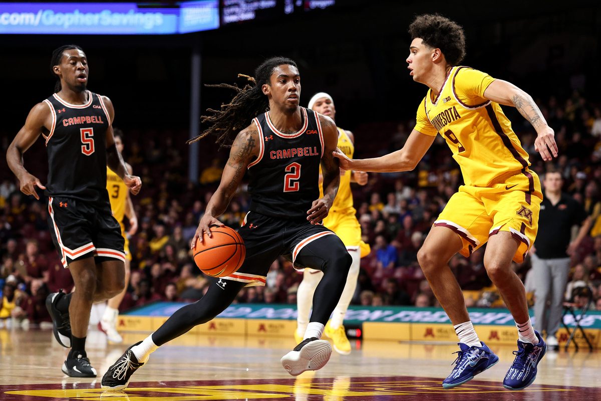 Dec 21, 2025; Minneapolis, Minnesota, USA; Campbell Fighting Camels guard Jeremiah Johnson (2) drives towards the basket as Minnesota Golden Gophers guard Kai Shinholster (9) defends during the second half at Williams Arena. Mandatory Credit: Matt Krohn-Imagn Images