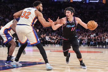 Dec 21, 2025; New York, New York, USA;  Miami Heat forward Jaime Jaquez Jr. (11) looks to drive past New York Knicks center Karl-Anthony Towns (32) in the fourth quarter at Madison Square Garden. Mandatory Credit: Wendell Cruz-Imagn Images