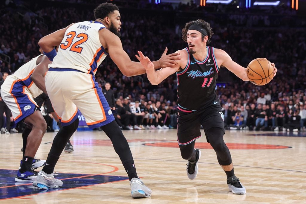 Dec 21, 2025; New York, New York, USA; Miami Heat forward Jaime Jaquez Jr. (11) looks to drive past New York Knicks center Karl-Anthony Towns (32) in the fourth quarter at Madison Square Garden. Mandatory Credit: Wendell Cruz-Imagn Images