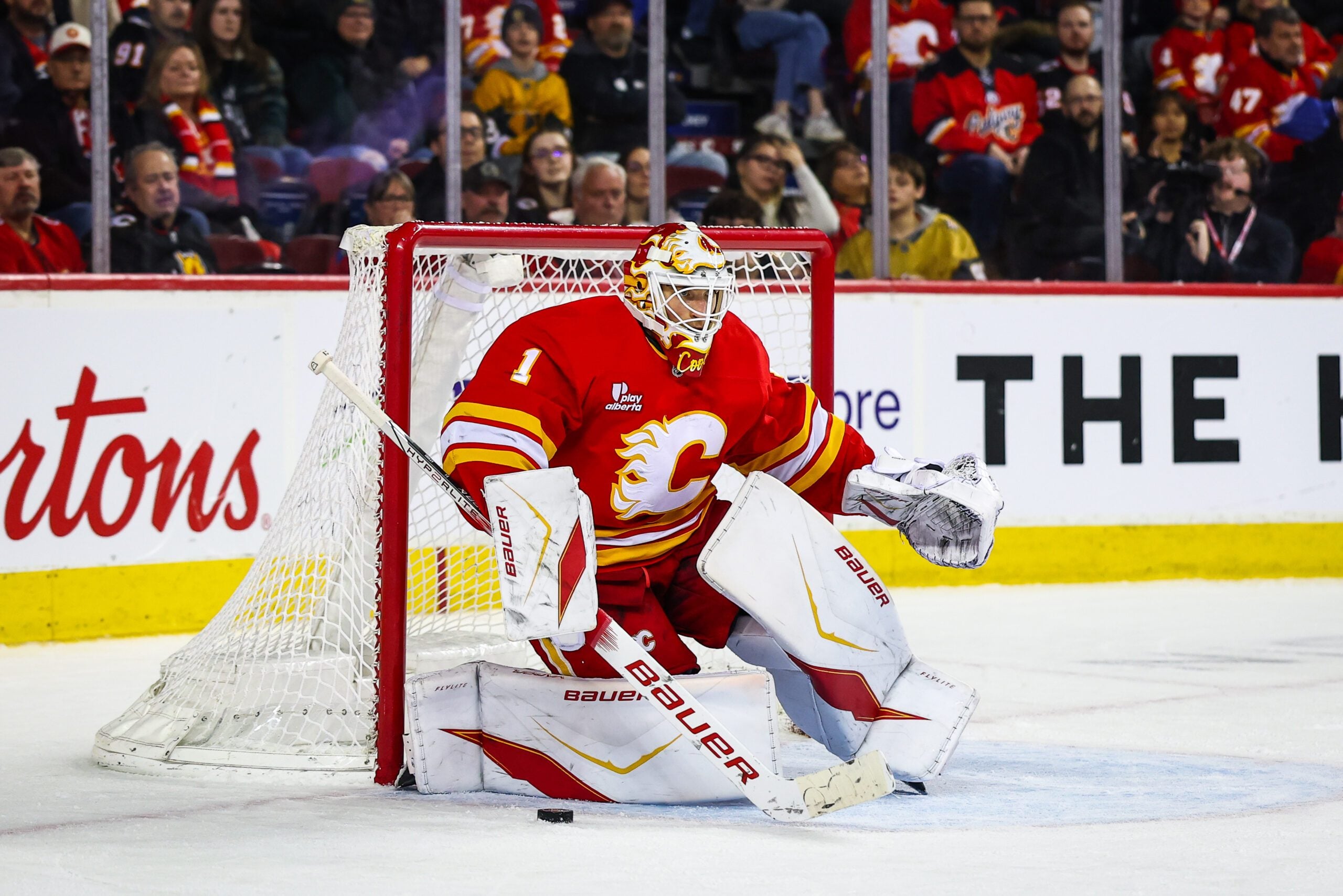 Dec 20, 2025; Calgary, Alberta, CAN; Calgary Flames goaltender Devin Cooley (1) guards his net against the Vegas Golden Knights during the third period at Scotiabank Saddledome. Mandatory Credit: Sergei Belski-Imagn Images