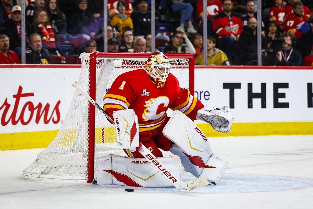 Dec 20, 2025; Calgary, Alberta, CAN; Calgary Flames goaltender Devin Cooley (1) guards his net against the Vegas Golden Knights during the third period at Scotiabank Saddledome. Mandatory Credit: Sergei Belski-Imagn Images