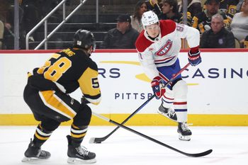 Dec 21, 2025; Pittsburgh, Pennsylvania, USA;  Montréal Canadiens center Oliver Kapanen (91) shoots the puck as Pittsburgh Penguins defenseman Kris Letang (58) defends during the second period at PPG Paints Arena. Mandatory Credit: Charles LeClaire-Imagn Images