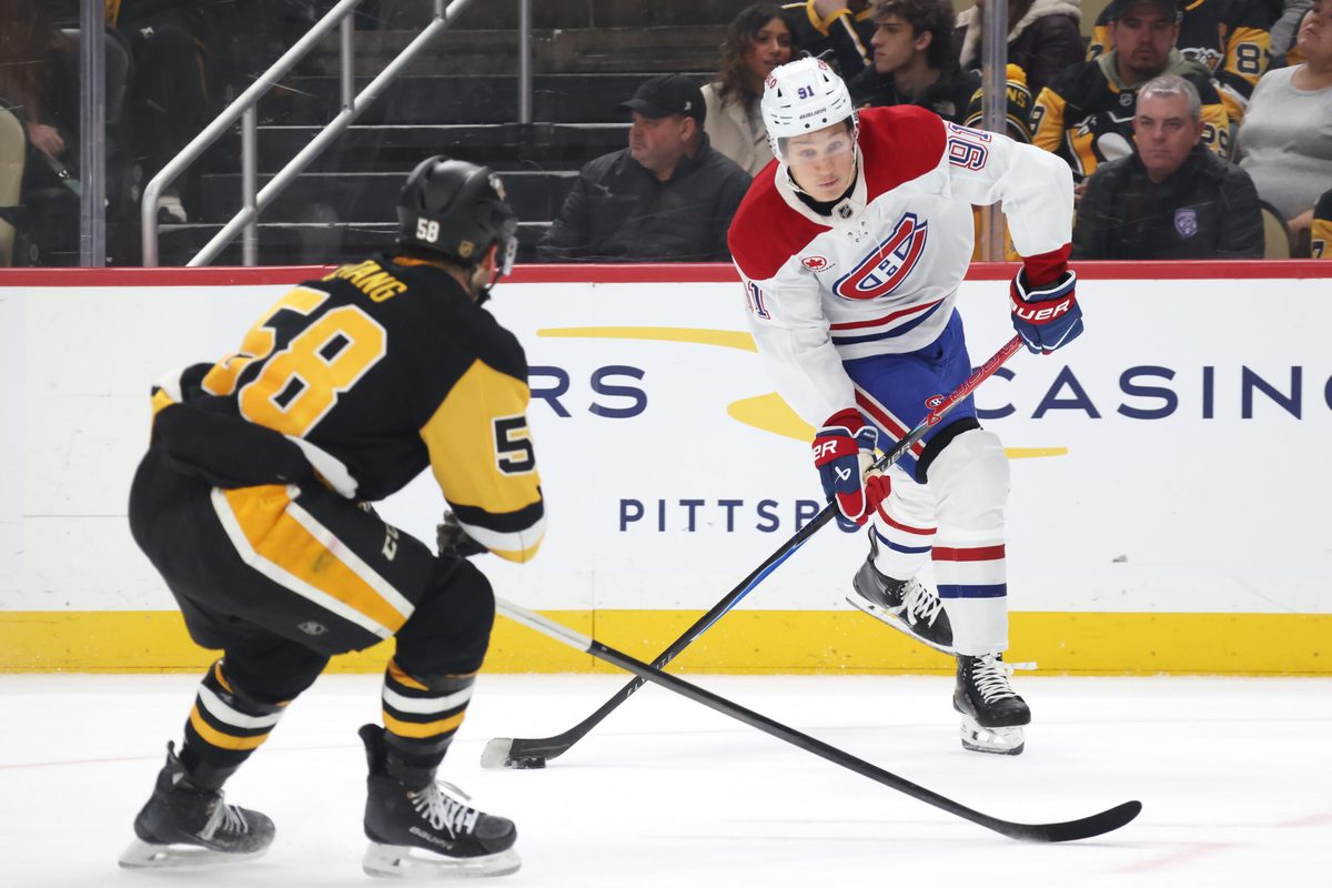 Dec 21, 2025; Pittsburgh, Pennsylvania, USA; Montréal Canadiens center Oliver Kapanen (91) shoots the puck as Pittsburgh Penguins defenseman Kris Letang (58) defends during the second period at PPG Paints Arena. Mandatory Credit: Charles LeClaire-Imagn Images