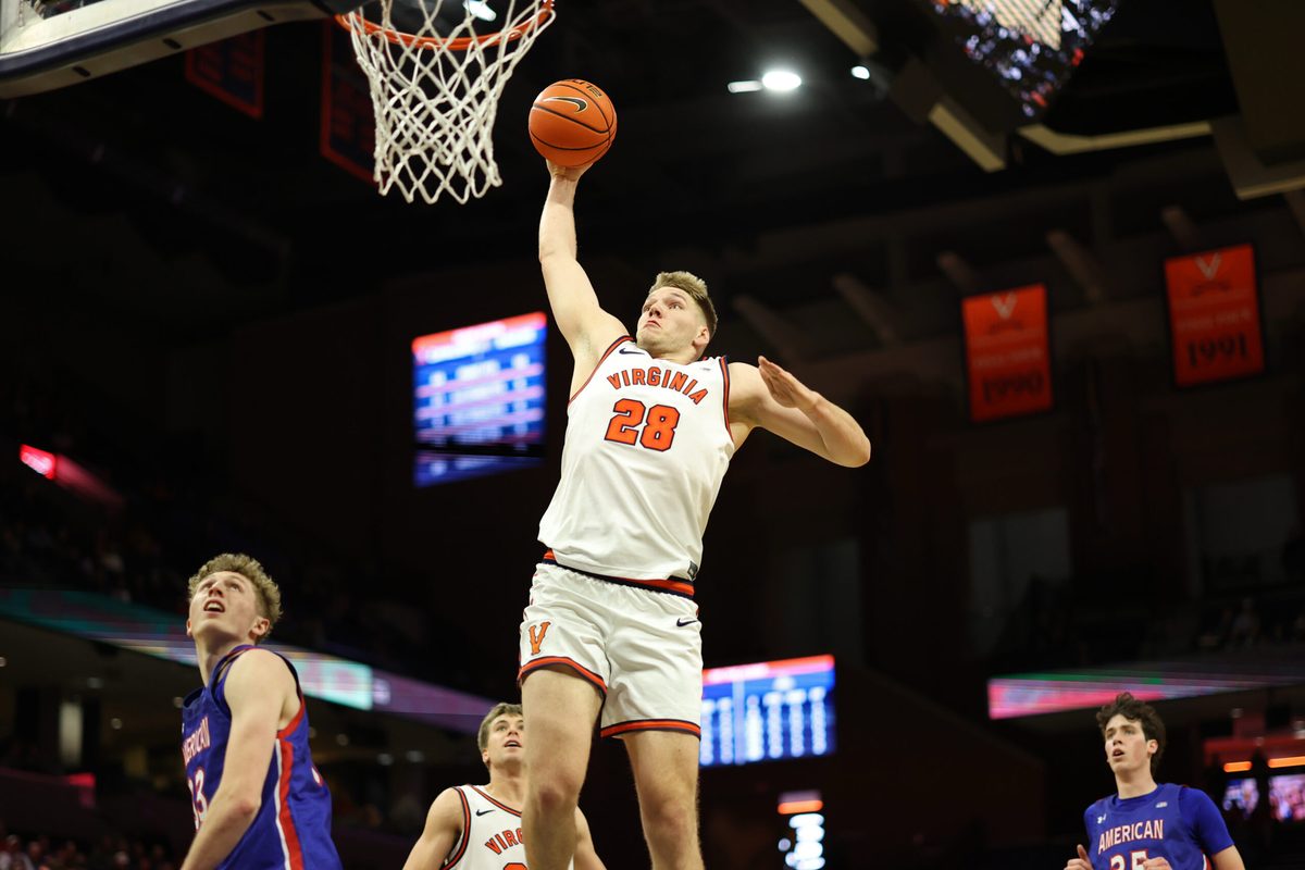 Dec 22, 2025; Charlottesville, Virginia, USA; Virginia Cavaliers forward Thijs de Ridder (28) dunks the ball as American University Eagles forward Matt Mayock (33) and  Eagles forward Chris Eagan (35) look on in the second half at John Paul Jones Arena. Mandatory Credit: Geoff Burke-Imagn Images