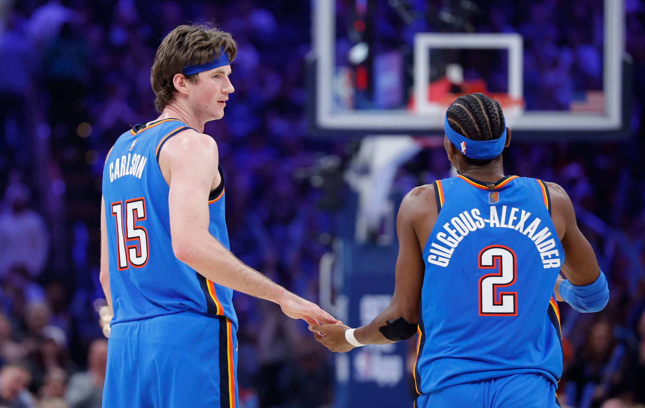 Dec 22, 2025; Oklahoma City, Oklahoma, USA; Oklahoma City Thunder center Branden Carlson (15) and guard Shai Gilgeous-Alexander (2) celebrate after a basket against the Memphis Grizzlies during the second half at Paycom Center. Mandatory Credit: Alonzo Adams-Imagn Images