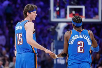 Dec 22, 2025; Oklahoma City, Oklahoma, USA; Oklahoma City Thunder center Branden Carlson (15) and guard Shai Gilgeous-Alexander (2) celebrate after a basket against the Memphis Grizzlies during the second half at Paycom Center. Mandatory Credit: Alonzo Adams-Imagn Images