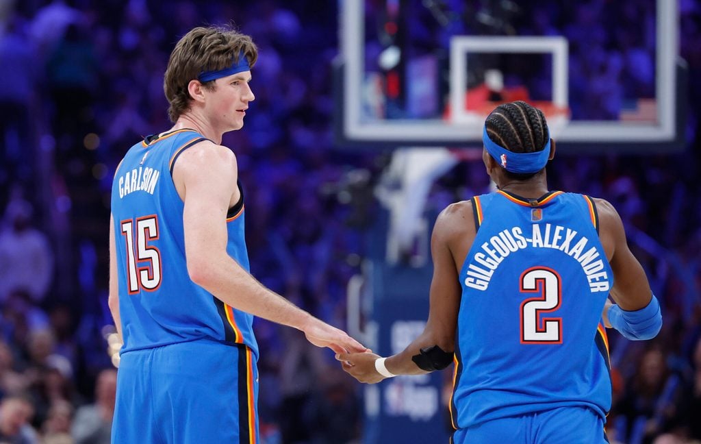 Dec 22, 2025; Oklahoma City, Oklahoma, USA; Oklahoma City Thunder center Branden Carlson (15) and guard Shai Gilgeous-Alexander (2) celebrate after a basket against the Memphis Grizzlies during the second half at Paycom Center. Mandatory Credit: Alonzo Adams-Imagn Images