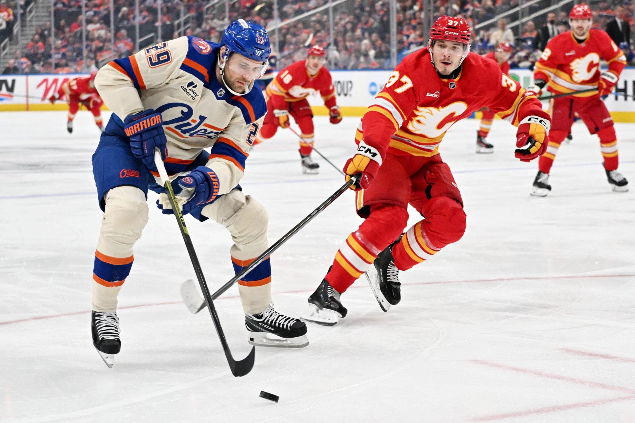 Dec 23, 2025; Edmonton, Alberta, CAN;  Edmonton Oilers center Leon Draisaitl (29) takes on the Calgary Flames defenseman Yan Kuznetsov (37) during the first period at Rogers Place. Mandatory Credit: Walter Tychnowicz-Imagn Images