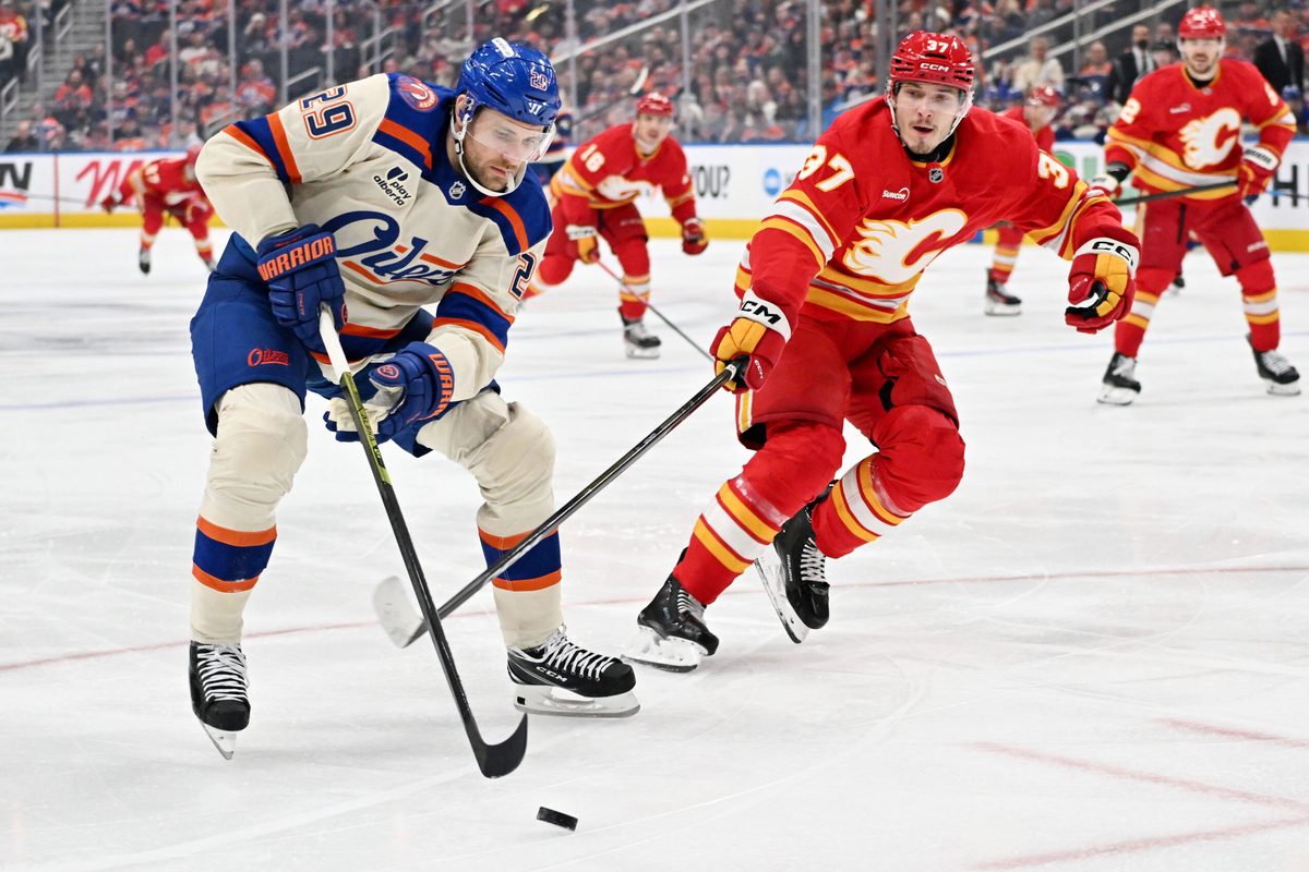 Dec 23, 2025; Edmonton, Alberta, CAN; Edmonton Oilers center Leon Draisaitl (29) takes on the Calgary Flames defenseman Yan Kuznetsov (37) during the first period at Rogers Place. Mandatory Credit: Walter Tychnowicz-Imagn Images