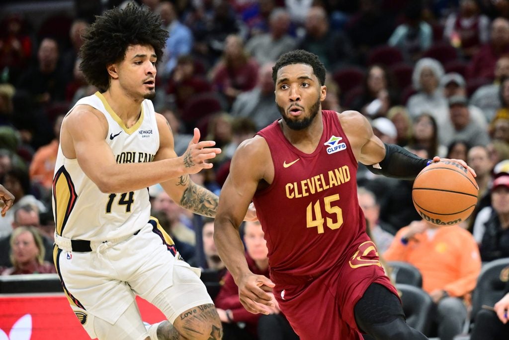 Dec 23, 2025; Cleveland, Ohio, USA; Cleveland Cavaliers guard Donovan Mitchell (45) drives to the basket against New Orleans Pelicans guard Micah Peavy (14) during the second half at Rocket Arena. Mandatory Credit: Ken Blaze-Imagn Images