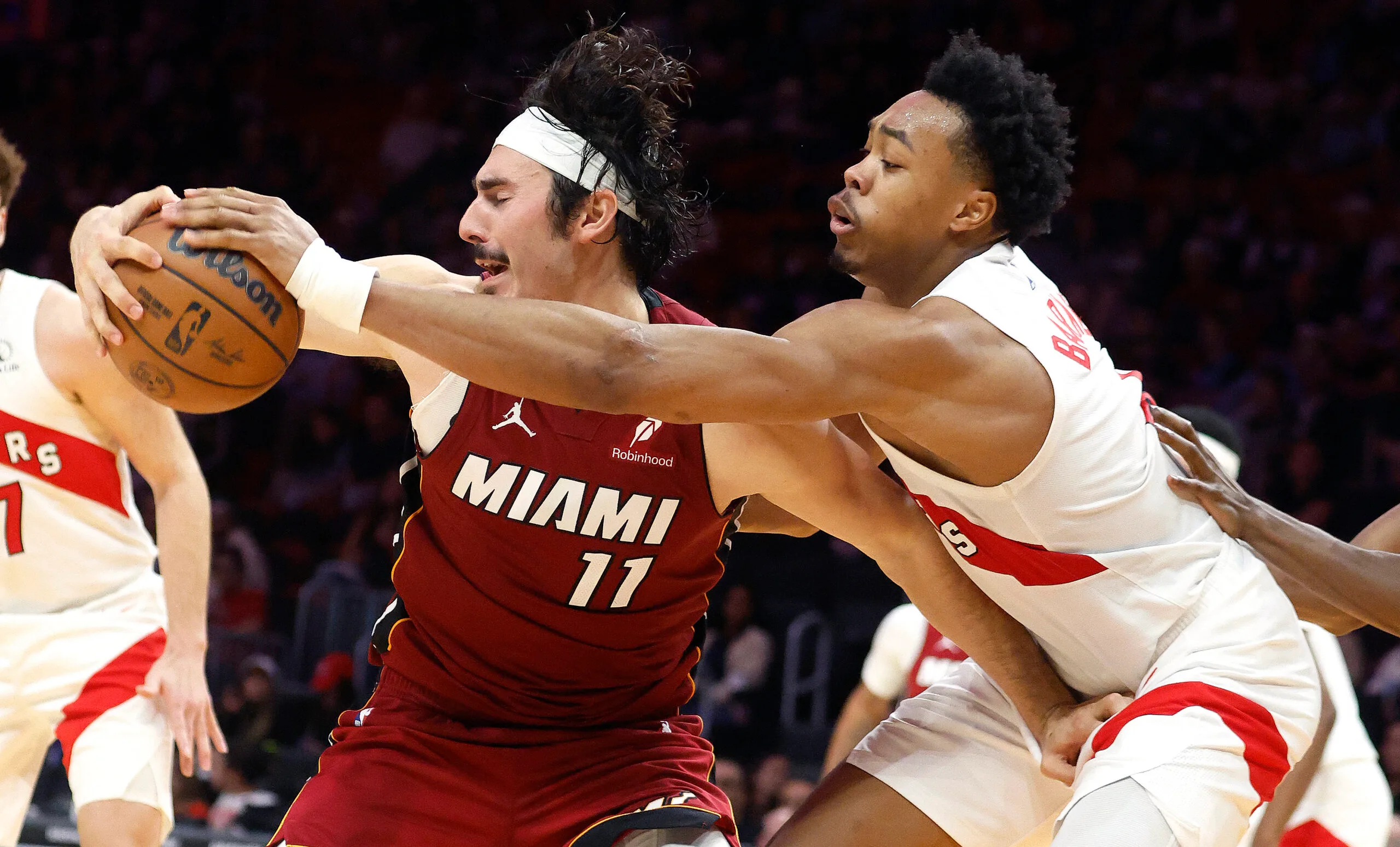 Dec 23, 2025; Miami, Florida, USA;  Toronto Raptors forward Scottie Barnes (4) knocks the ball away from Miami Heat forward Jaime Jaquez Jr. (11) during the second half at Kaseya Center. Mandatory Credit: Rhona Wise-Imagn Images