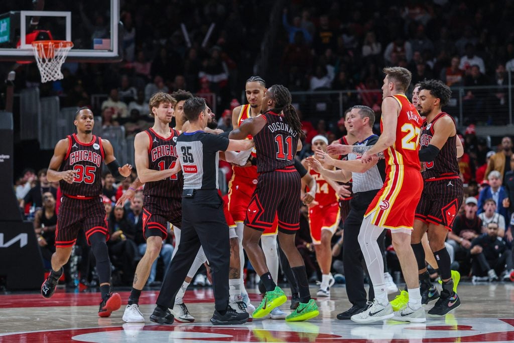 Dec 23, 2025; Atlanta, Georgia, USA; Atlanta Hawks guard Trae Young (11) starts a verbal altercation against Chicago Bulls guard Ayo Dosunmu (11) then referee Jason Goldenberg (35), guard Vit Krejci (27), forward Zaccharie Risacher (10), forward Matas Buzelis (14), guard Josh Giddey (3), and guard Tre Jones (30) step in during the fourth quarter at State Farm Arena. Mandatory Credit: Jordan Godfree-Imagn Images