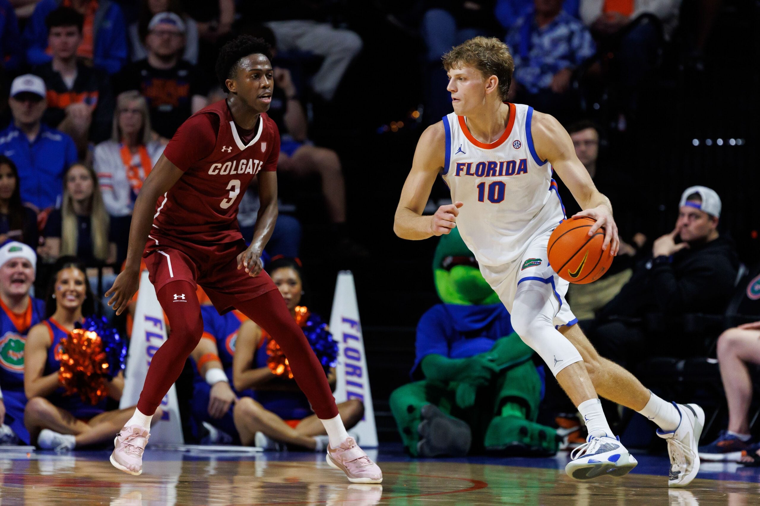 Dec 21, 2025; Gainesville, Florida, USA; Florida Gators forward Thomas Haugh (10) dribbles the ball while Colgate Raiders guard Jalen Cox (3) defends during the first half at Exactech Arena at the Stephen C. O'Connell Center. Mandatory Credit: Matt Pendleton-Imagn Images