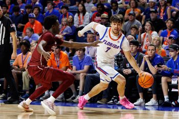 Dec 21, 2025; Gainesville, Florida, USA; Florida Gators guard Urban Klavzar (7) drives to the basket past Colgate Raiders guard Jalen Cox (3) during the second half at Exactech Arena at the Stephen C. O'Connell Center. Mandatory Credit: Matt Pendleton-Imagn Images