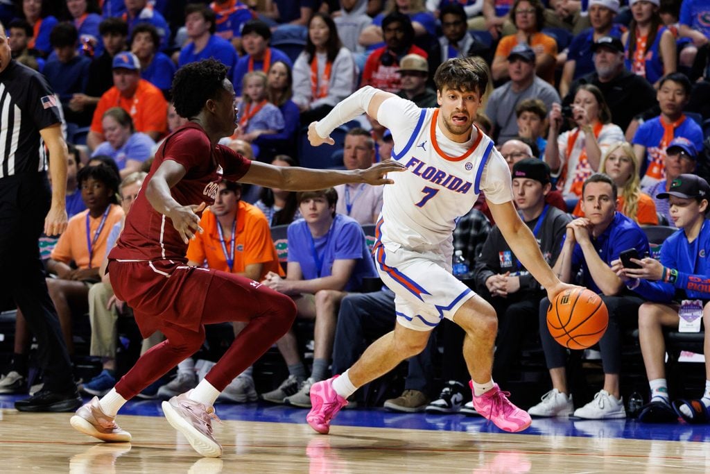 Dec 21, 2025; Gainesville, Florida, USA; Florida Gators guard Urban Klavzar (7) drives to the basket past Colgate Raiders guard Jalen Cox (3) during the second half at Exactech Arena at the Stephen C. O'Connell Center. Mandatory Credit: Matt Pendleton-Imagn Images