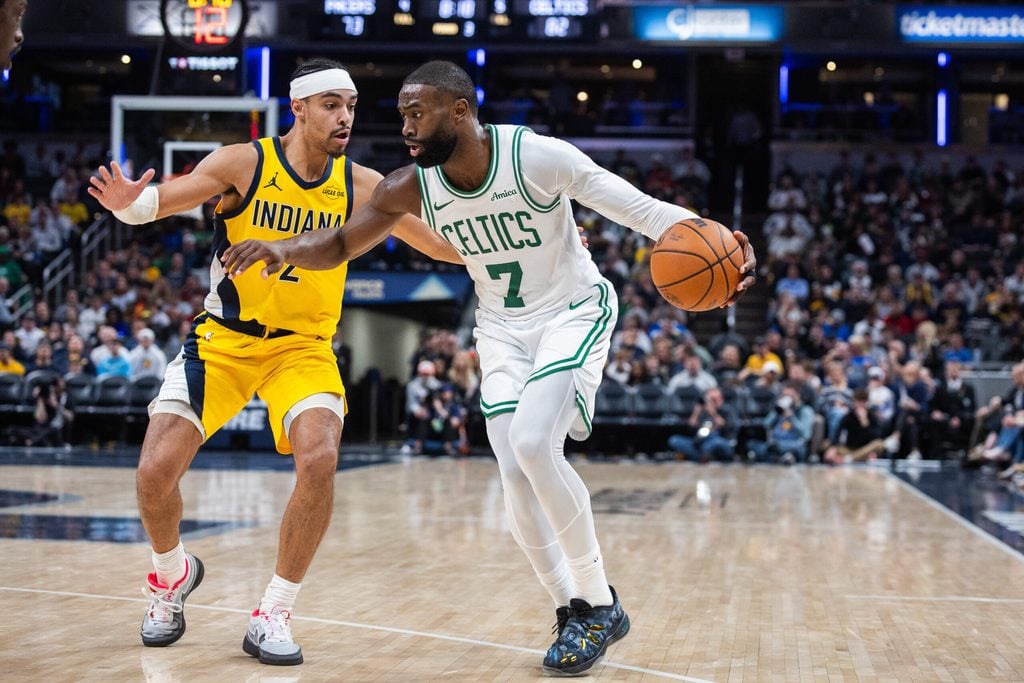 Dec 26, 2025; Indianapolis, Indiana, USA; Boston Celtics guard/forward Jaylen Brown (7) dribbles the ball while Indiana Pacers guard/forward Andrew Nembhard (2) defends in the second half at Gainbridge Fieldhouse. Mandatory Credit: Trevor Ruszkowski-Imagn Images