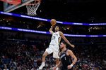 Dec 26, 2025; New Orleans, Louisiana, USA; New Orleans Pelicans forward Trey Murphy III (25) dunks against Phoenix Suns guard Devin Booker (1) during the second half at Smoothie King Center. Mandatory Credit: Matthew Hinton-Imagn Images