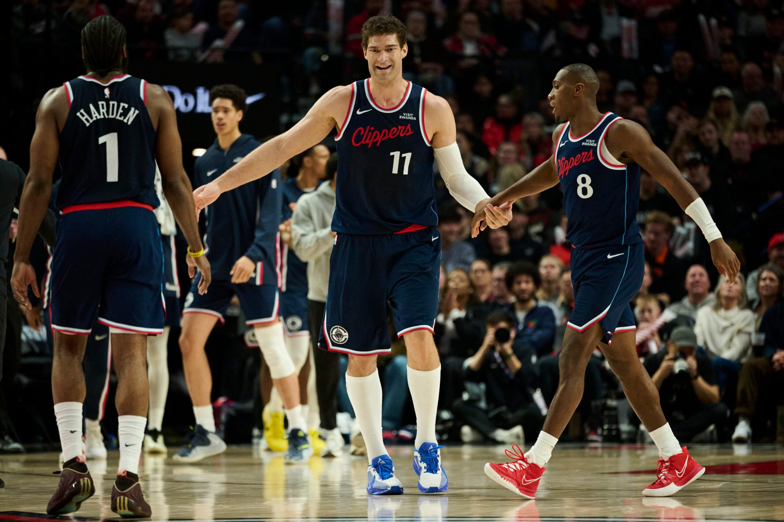Dec 26, 2025; Portland, Oregon, USA; LA Clippers center Brook Lopez (11) high fives teammates during the second half against the Portland Trail Blazers at Moda Center. Mandatory Credit: Troy Wayrynen-Imagn Images