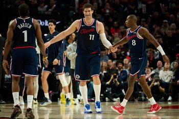 Dec 26, 2025; Portland, Oregon, USA; LA Clippers center Brook Lopez (11) high fives teammates during the second half against the Portland Trail Blazers at Moda Center. Mandatory Credit: Troy Wayrynen-Imagn Images