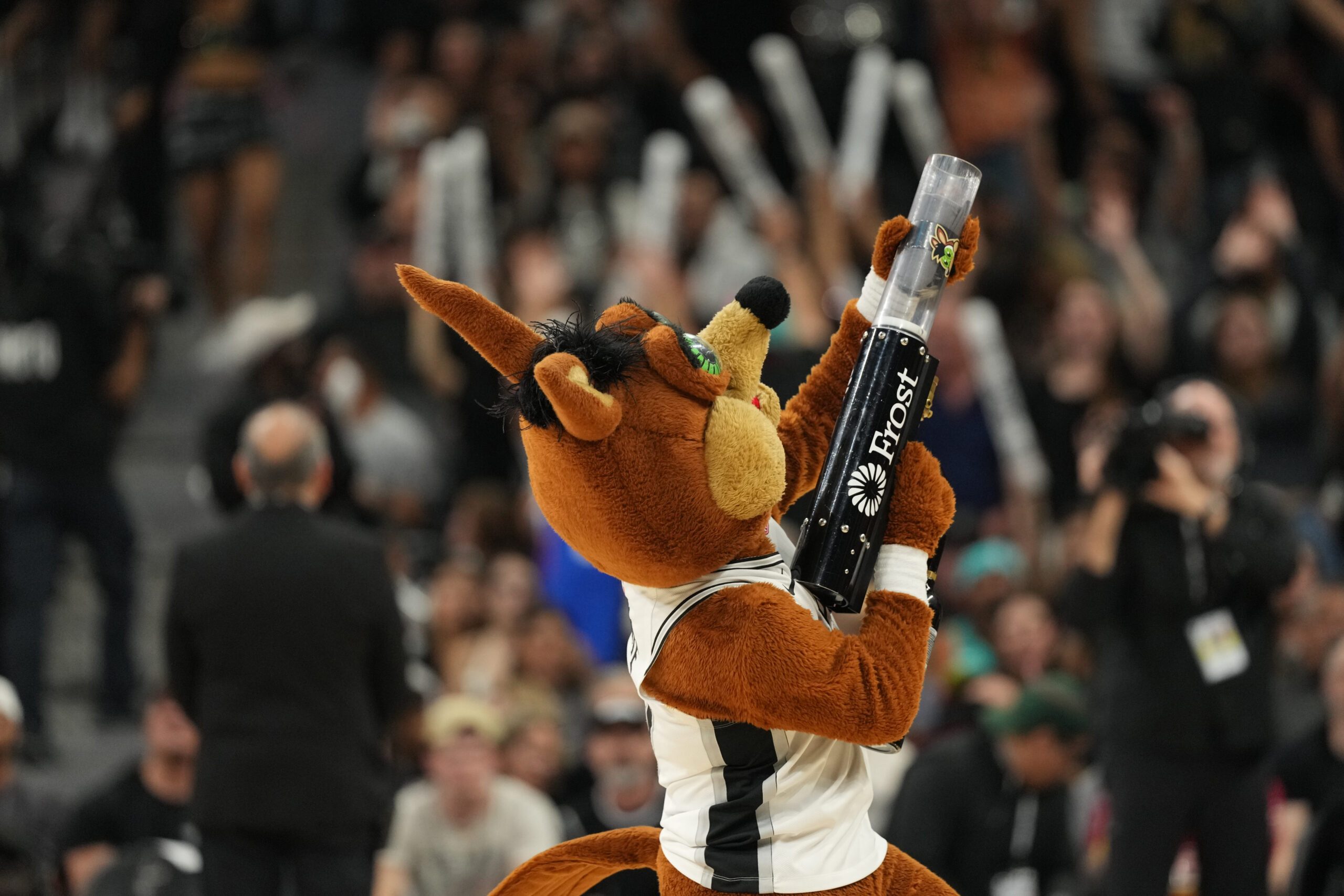 Dec 27, 2025; San Antonio, Texas, USA; San Antonio Spurs mascot Coyote sends t-shirts in to the crowd during the second half against the Utah Jazz at Frost Bank Center. Mandatory Credit: Scott Wachter-Imagn Images