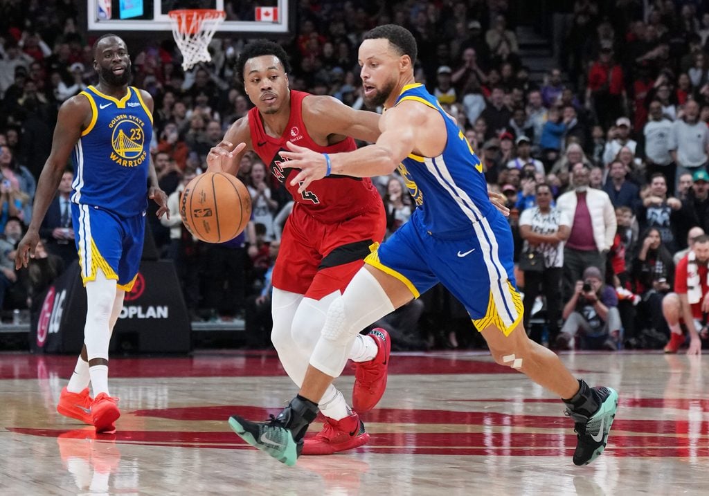 Dec 28, 2025; Toronto, Ontario, CAN; Golden State Warriors guard Stephen Curry (30) battles for the ball with Toronto Raptors forward Scottie Barnes (4) during the fourth quarter at Scotiabank Arena. Mandatory Credit: Nick Turchiaro-Imagn Images