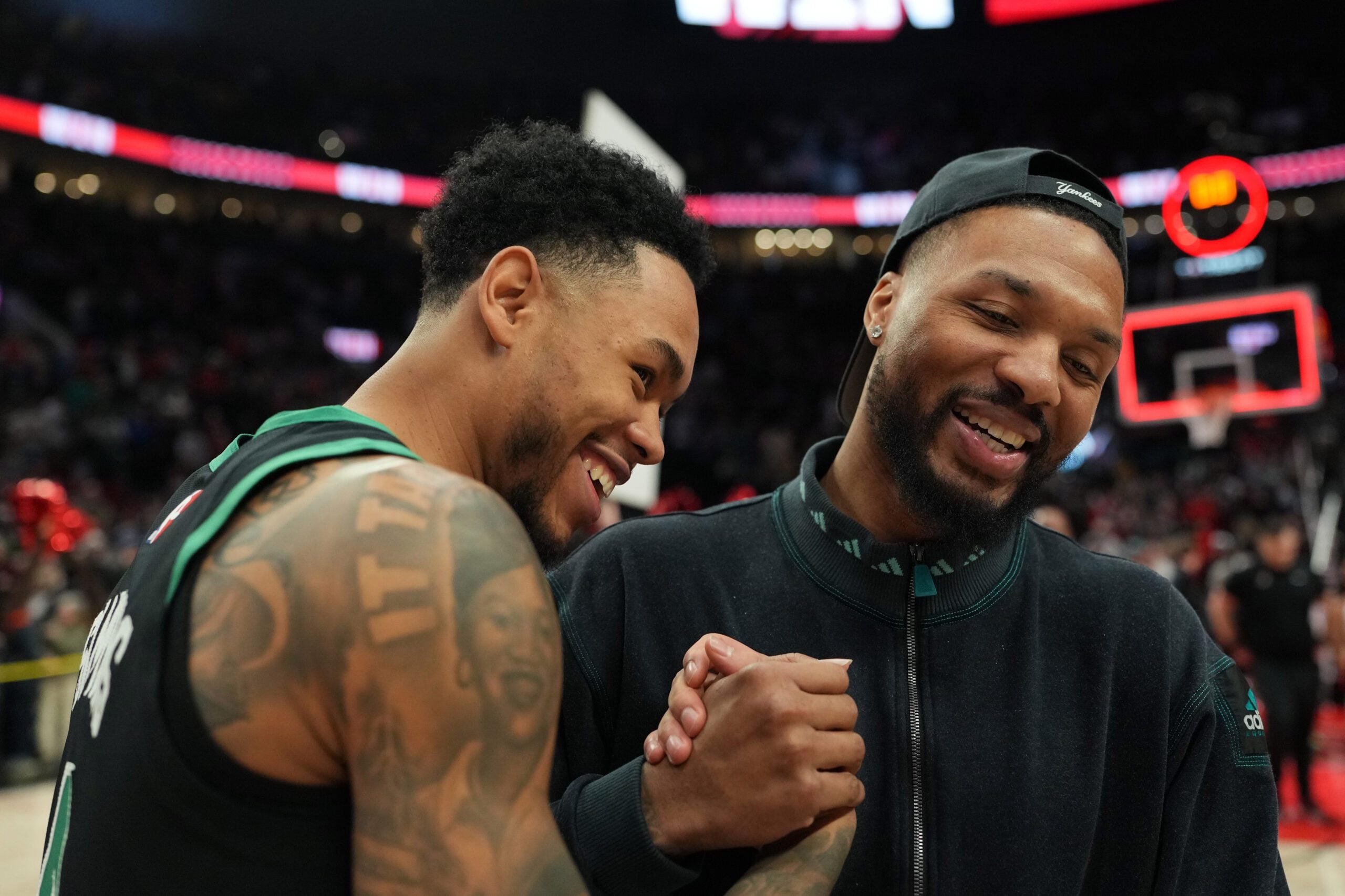 Dec 28, 2025; Portland, Oregon, USA; Boston Celtics guard Anfernee Simons (4) and Portland Trail Blazers guard Damian Lillard (0) meet after the game at Moda Center. Mandatory Credit: Soobum Im-Imagn Images