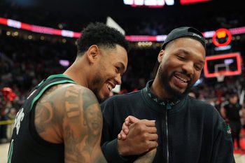 Dec 28, 2025; Portland, Oregon, USA; Boston Celtics guard Anfernee Simons (4) and Portland Trail Blazers guard Damian Lillard (0) meet after the game at Moda Center. Mandatory Credit: Soobum Im-Imagn Images