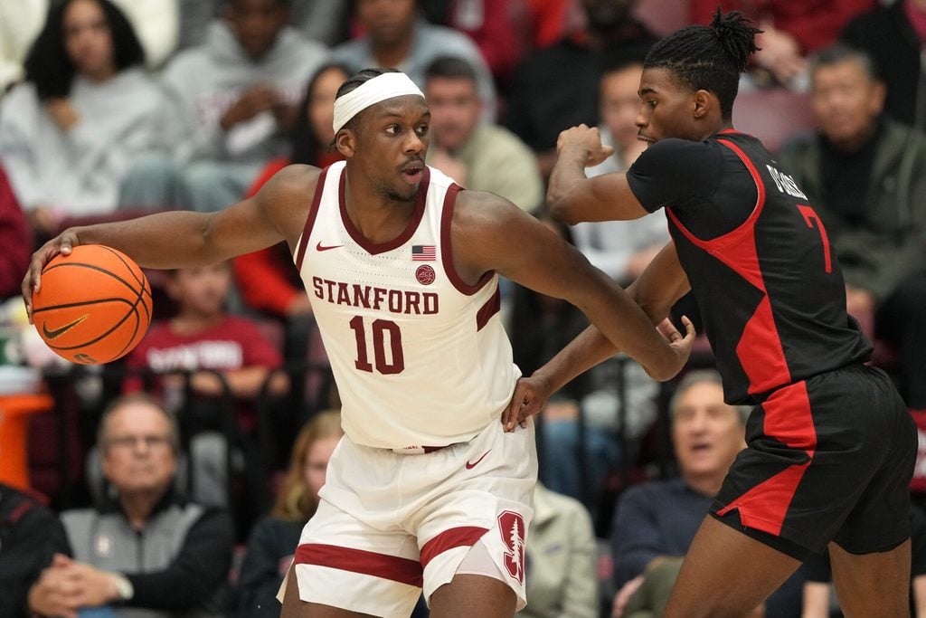 Dec 27, 2025; Stanford, California, USA; Stanford Cardinal forward Chisom Okpara (10) dribbles against CSUN Matadors guard Joshua O'Garro (7) during the fourth quarter at Maples Pavilion. Mandatory Credit: Darren Yamashita-Imagn Images