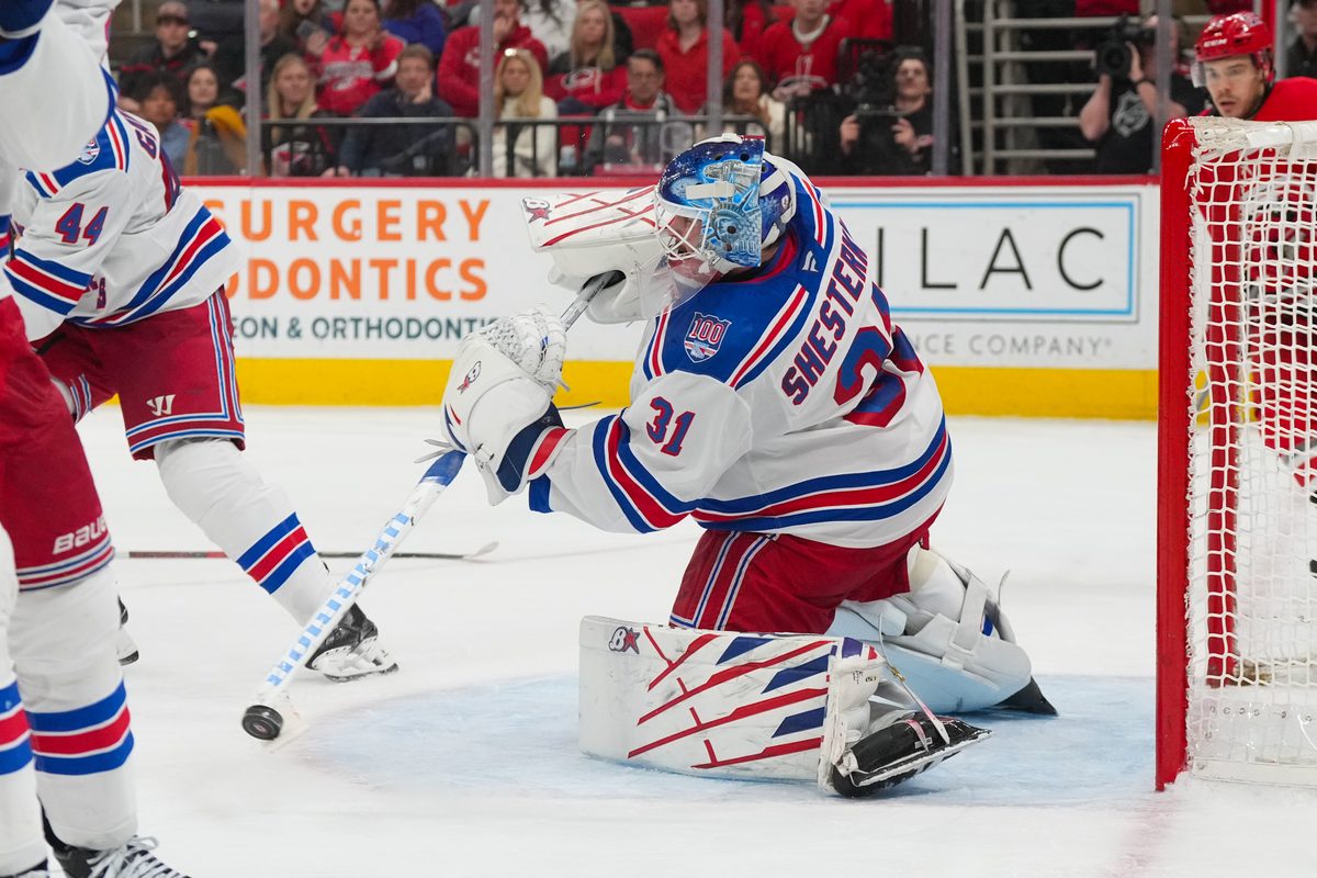Dec 29, 2025; Raleigh, North Carolina, USA; New York Rangers goaltender Igor Shesterkin (31) clears the puck away against the Carolina Hurricanes during the third period at Lenovo Center. Mandatory Credit: James Guillory-Imagn Images