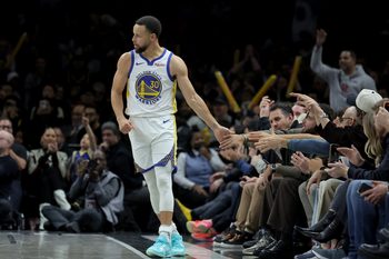 Dec 29, 2025; Brooklyn, New York, USA; Golden State Warriors guard Stephen Curry (30) high fives a fan during the fourth quarter against the Brooklyn Nets at Barclays Center. Mandatory Credit: Brad Penner-Imagn Images