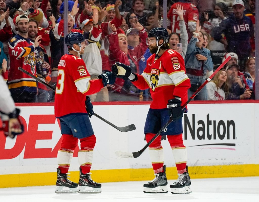 Dec 29, 2025; Sunrise, Florida, USA; Florida Panthers defenseman Aaron Ekblad (5) and center Sam Reinhart (13) celebrate his goal against the Washington Capitals during the third period at Amerant Bank Arena. Mandatory Credit: Jeff Romance-Imagn Images