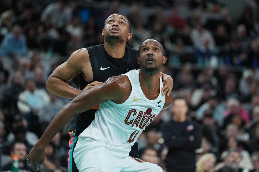 Dec 29, 2025; San Antonio, Texas, USA; Cleveland Cavaliers center Evan Mobley (4) blocks out San Antonio Spurs forward Keldon Johnson (3) in the second half at Frost Bank Center. Mandatory Credit: Daniel Dunn-Imagn Images