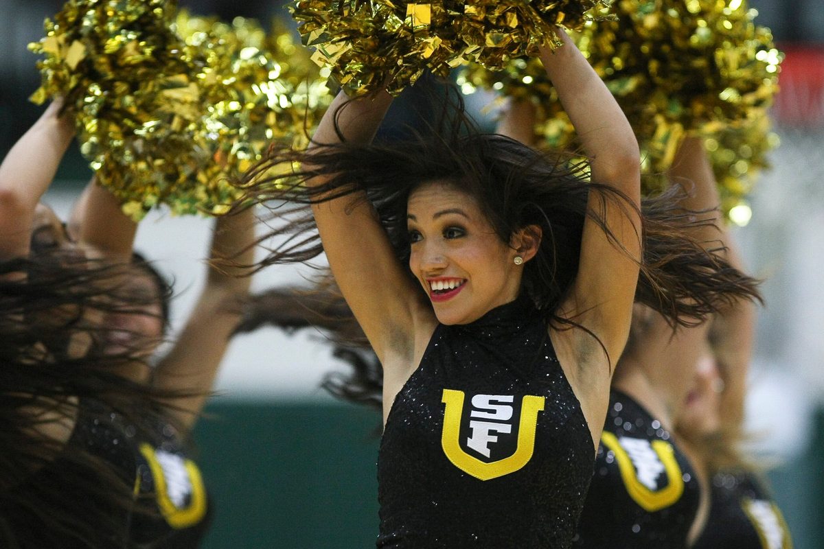 Dec 4, 2012; San Francisco, CA, USA; San Francisco Dons cheerleader performs against the St. John's Red Storm during the second half at Memorial Gymnasium.   The San Francisco Dons defeated the St. John's Red Storm 81-65. Mandatory Credit: Kelley L Cox-Imagn Images