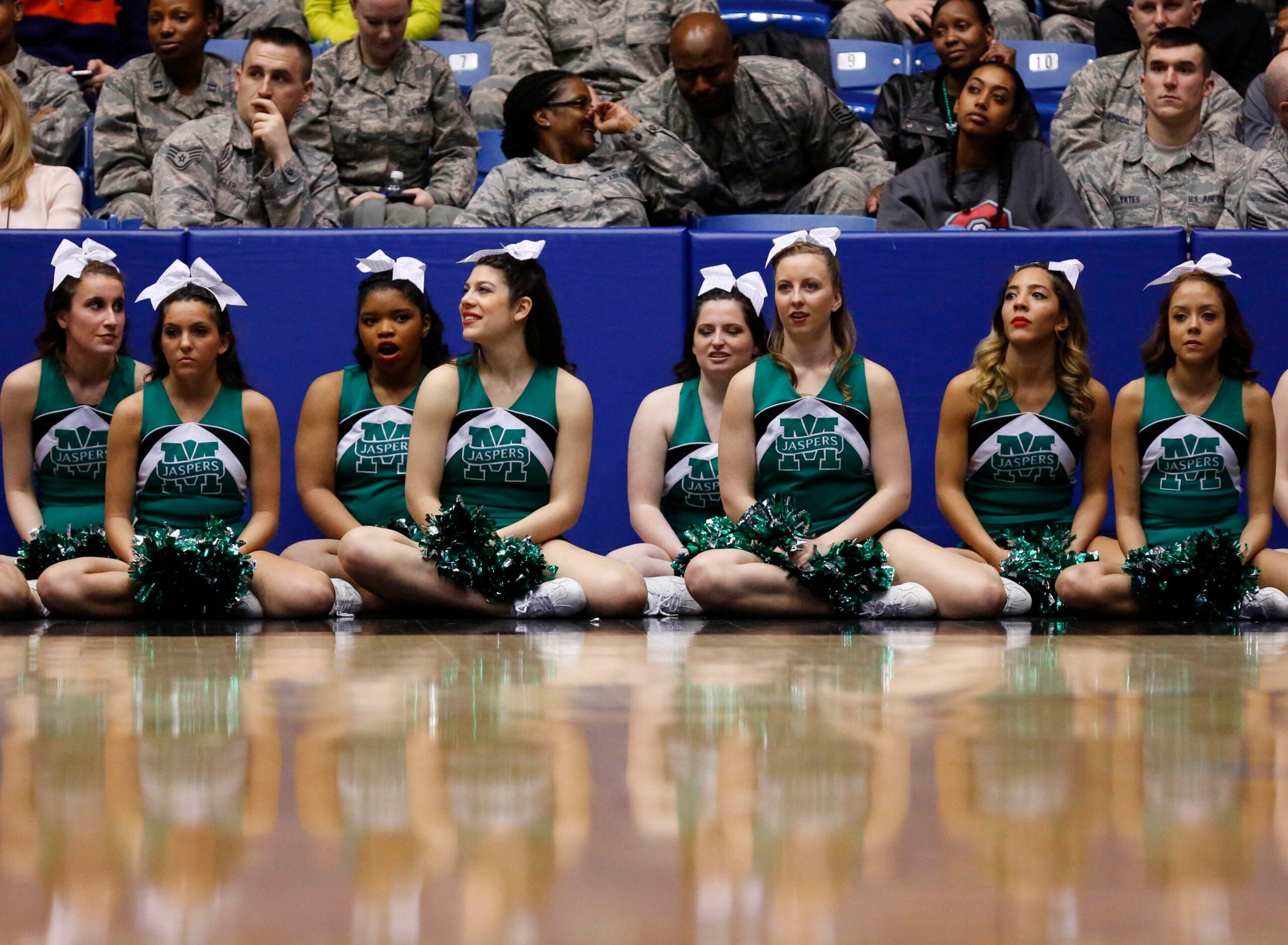 Mar 17, 2015; Dayton, OH, USA; Manhattan Jaspers cheerleaders sit court side during the first half against the Hampton Pirates in the first round of the 2015 NCAA Tournament at UD Arena. Mandatory Credit: Rick Osentoski-Imagn Images