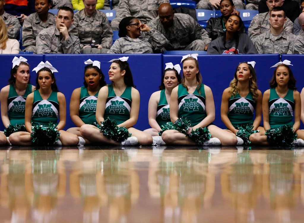 Mar 17, 2015; Dayton, OH, USA; Manhattan Jaspers cheerleaders sit court side during the first half against the Hampton Pirates in the first round of the 2015 NCAA Tournament at UD Arena. Mandatory Credit: Rick Osentoski-Imagn Images