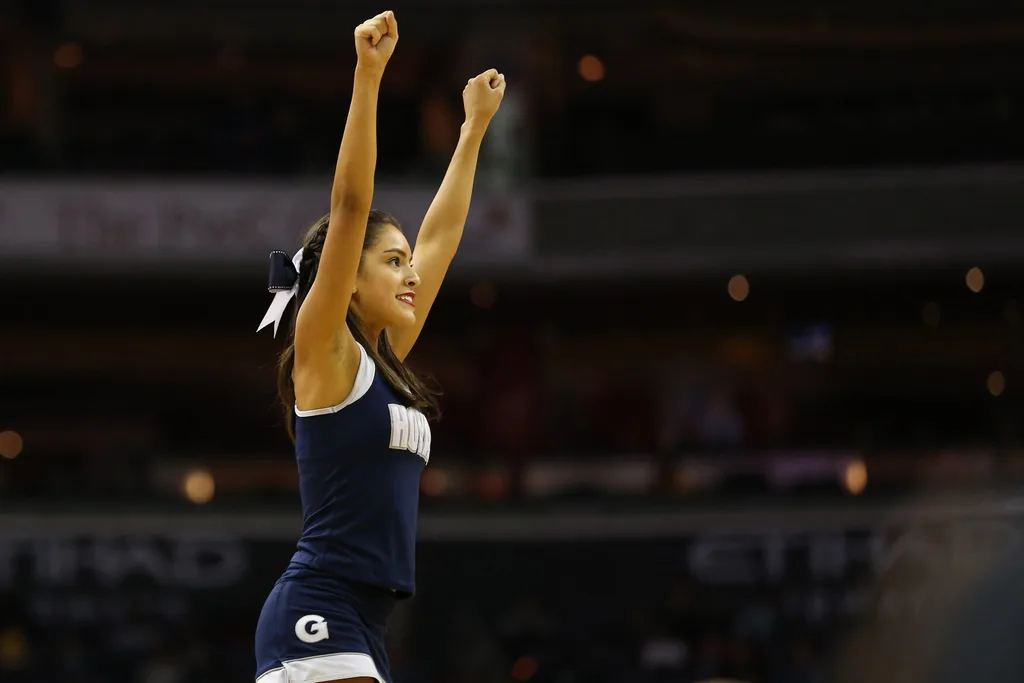 Feb 11, 2017; Washington, DC, USA; A Georgetown Hoyas cheerleader waves to fans in the stands during a timeout against the Marquette Golden Eagles in the second half at Verizon Center. The Hoyas won 80-62. Mandatory Credit: Geoff Burke-Imagn Images