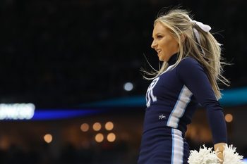 Mar 17, 2018; Pittsburgh, PA, USA; A Rhode Island Rams cheerleader cheers against the Duke Blue Devils in the second round of the 2018 NCAA Tournament at PPG Paints Arena. Mandatory Credit: Geoff Burke-Imagn Images