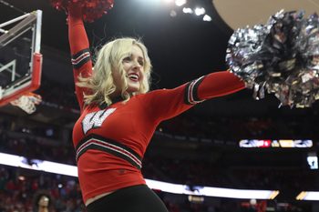 Dec 21, 2019; Madison, Wisconsin, USA; A Wisconsin Badgers cheerleader entertains the fans before the game with the Wisconsin Milwaukee Panthers at the Kohl Center. Mandatory Credit: Mary Langenfeld-Imagn Images