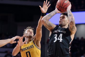 Cincinnati Bearcats guard Jarron Cumberland (34) shoots as Wichita State Shockers guard Dexter Dennis (0) guards in the second half of the NCAA men's basketball game on Sunday, Feb. 23, 2020, in Fifth Third Arena at the University of Cincinnati. Cincinnati Bearcats defeated Wichita State Shockers 67-64.

Cincinnati Bearcats Wichita State Shockers 256