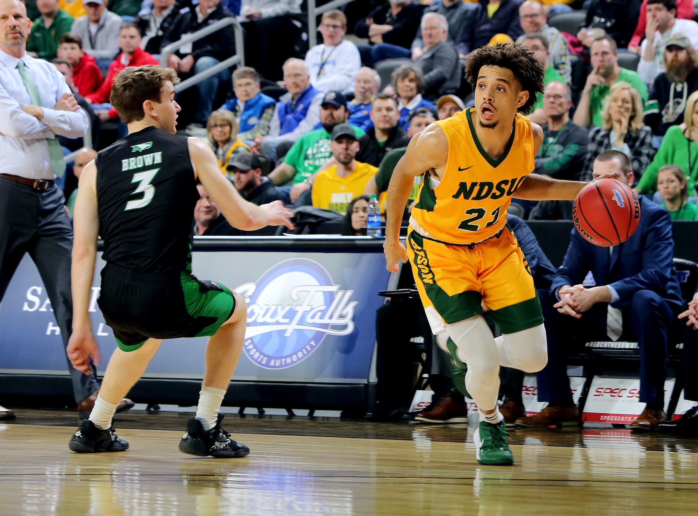 SIOUX FALLS, SD - MARCH 10: Jarius Cook #21 of the North Dakota State Bison drives baseline past Billy Brown #3 of the North Dakota Fighting Hawks during the men   s championship game at the 2020 Summit League Basketball Tournament in Sioux Falls, SD. (Photo by Dave Eggen/Inertia)

Summit League Basketball Tournament