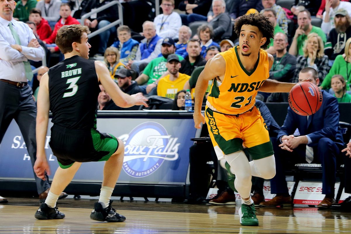 SIOUX FALLS, SD - MARCH 10: Jarius Cook #21 of the North Dakota State Bison drives baseline past Billy Brown #3 of the North Dakota Fighting Hawks during the men   s championship game at the 2020 Summit League Basketball Tournament in Sioux Falls, SD. (Photo by Dave Eggen/Inertia)

Summit League Basketball Tournament