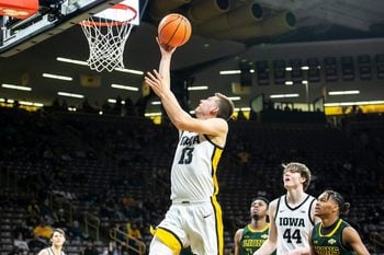 Iowa guard Austin Ash (13) makes a basket during a NCAA non-conference men's basketball game against Southeastern Louisiana, Tuesday, Dec. 21, 2021, at Carver-Hawkeye Arena in Iowa City, Iowa.

211221 Se Louisiana Iowa Mbb 037 Jpg
